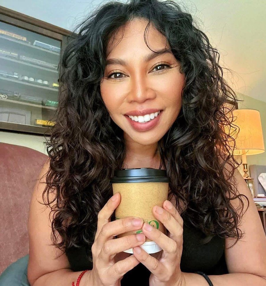Odette Orola, founder of The Glow Method and Odette&rsquo;s Bakery, holding a cup of coffee
